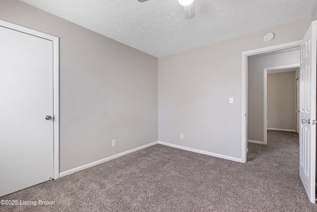 unfurnished bedroom with ceiling fan, a textured ceiling, baseboards, and carpet flooring