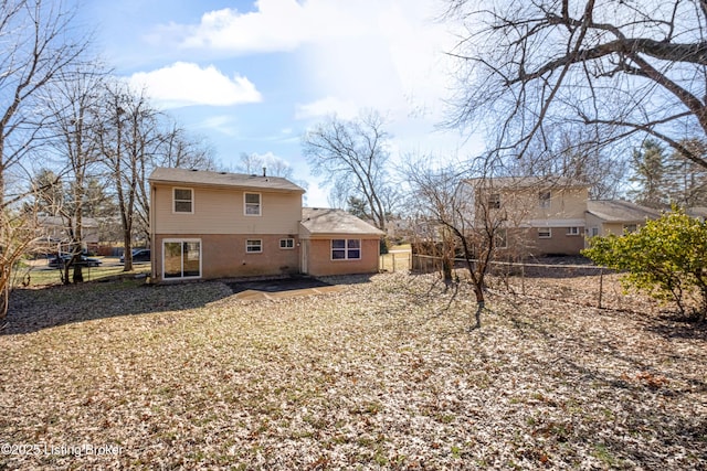 rear view of property with fence