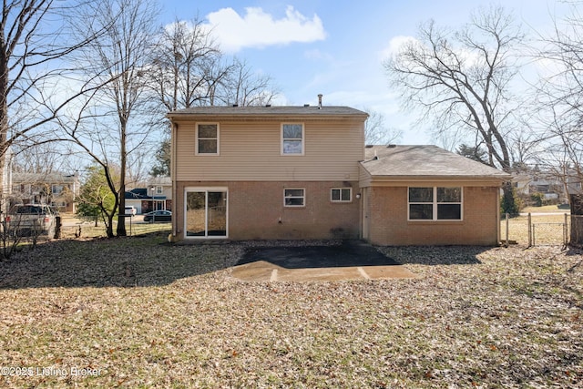 back of house with a patio, brick siding, and fence