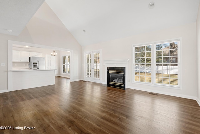 1523 Yorkshire Dr, Elizabethtown, KY 42701 - unfurnished living room with dark wood-type flooring, a healthy amount of sunlight, a fireplace, and visible vents