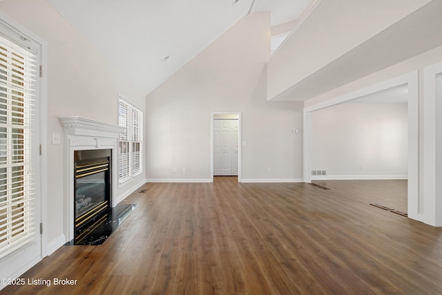 1523 Yorkshire Dr, Elizabethtown, KY 42701 - unfurnished living room with high vaulted ceiling, wood finished floors, visible vents, baseboards, and a glass covered fireplace