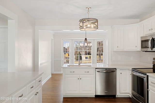 1523 Yorkshire Dr, Elizabethtown, KY 42701 - kitchen featuring white cabinets, dark wood finished floors, appliances with stainless steel finishes, a chandelier, and a sink