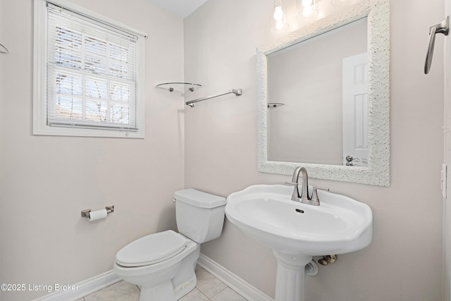 1523 Yorkshire Dr, Elizabethtown, KY 42701 - half bathroom with toilet, tile patterned flooring, baseboards, and a sink