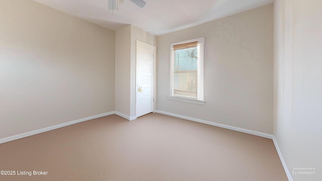 carpeted empty room with a ceiling fan and baseboards