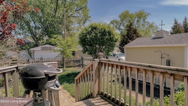 wooden deck featuring a grill and fence