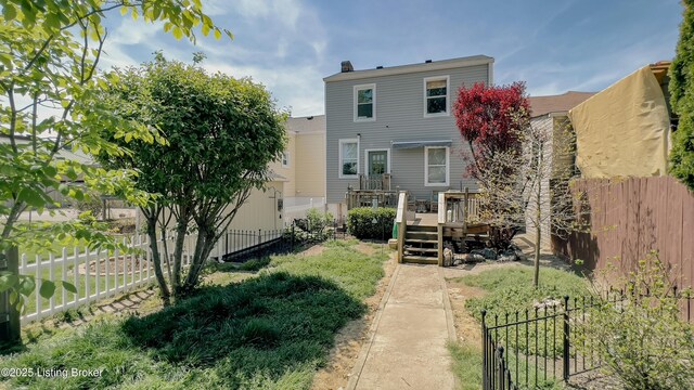 back of house featuring a fenced backyard and a wooden deck