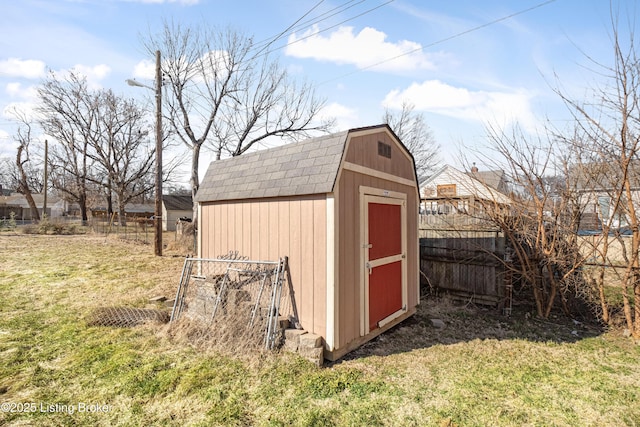 view of shed featuring fence