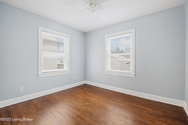 spare room featuring ceiling fan, a textured ceiling, baseboards, and wood finished floors