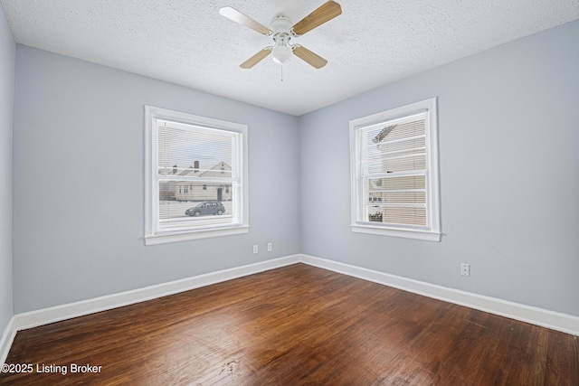 unfurnished room with ceiling fan, a textured ceiling, wood finished floors, and baseboards