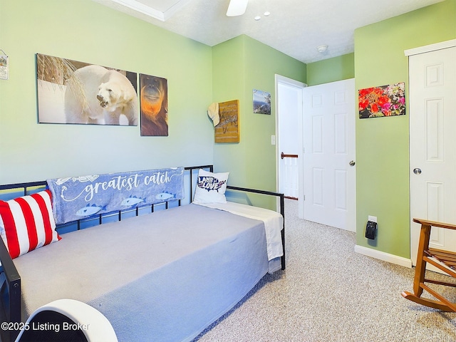 bedroom featuring carpet and baseboards