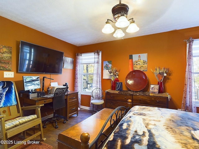 bedroom with baseboards and wood finished floors