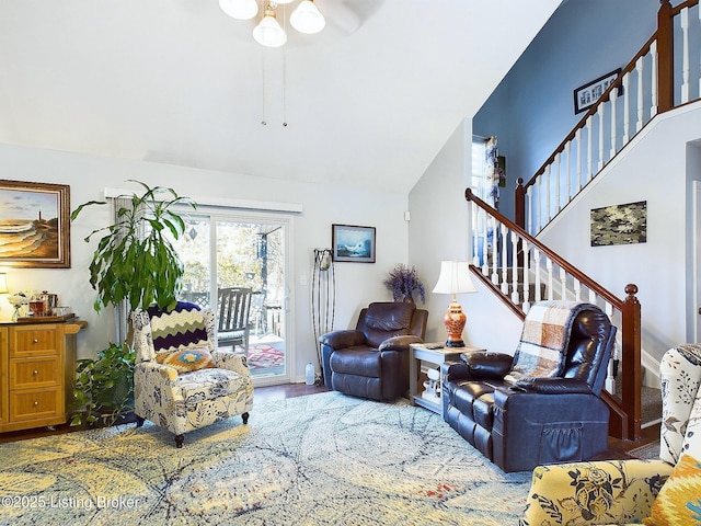 living area with stairs, wood finished floors, and lofted ceiling