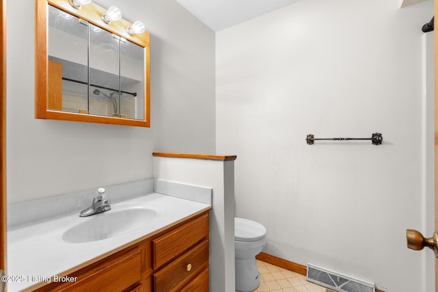 bathroom featuring visible vents, vanity, toilet, and tile patterned floors