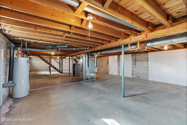 unfinished basement featuring water heater, heating unit, and stairs