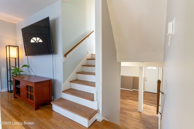 stairs featuring wood finished floors