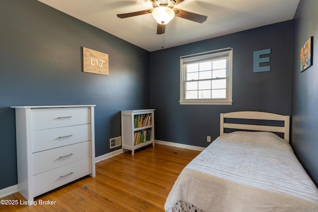 bedroom featuring light wood-type flooring, baseboards, and visible vents