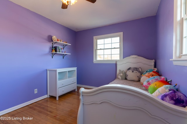 bedroom featuring baseboards, ceiling fan, and hardwood / wood-style floors