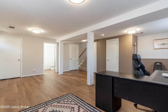 office featuring light wood-style floors, visible vents, and baseboards