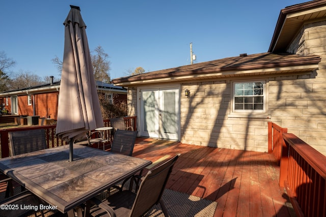 wooden terrace with outdoor dining area