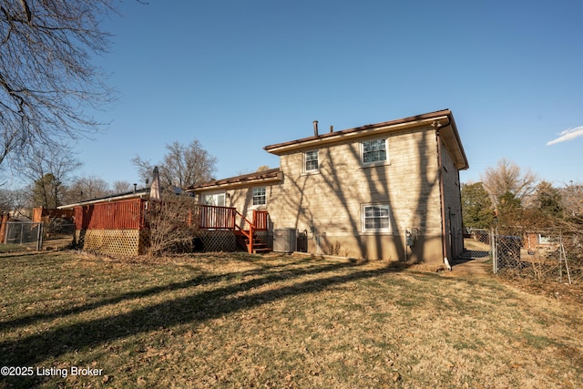 rear view of property featuring central AC, fence, a wooden deck, and a lawn