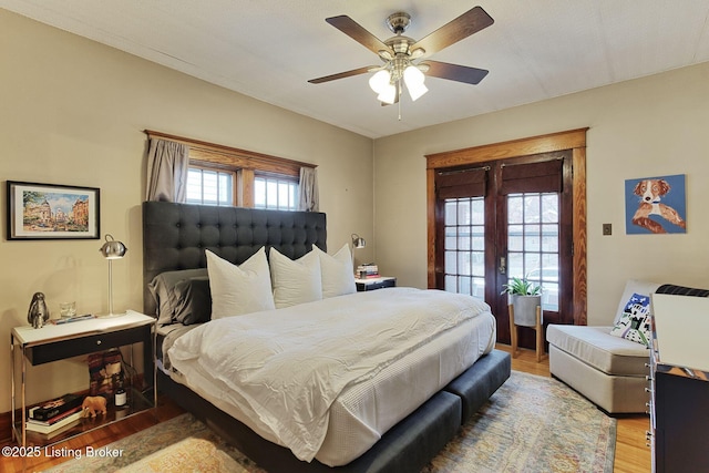 bedroom with light wood-style flooring and a ceiling fan