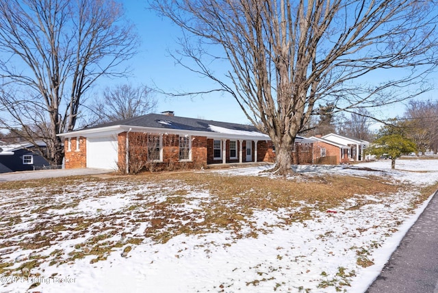 single story home featuring a garage, brick siding, and a chimney