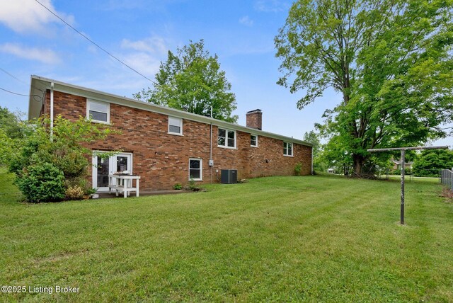1217 Seneca Trl, Frankfort, KY 40601 - rear view of house with a chimney, a yard, central air condition unit, and brick siding