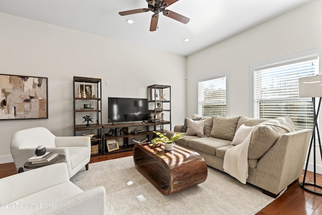 living room featuring light wood-style flooring, a ceiling fan, and recessed lighting