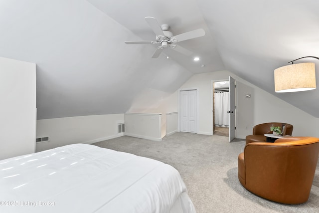 bedroom with light colored carpet, visible vents, vaulted ceiling, and baseboards