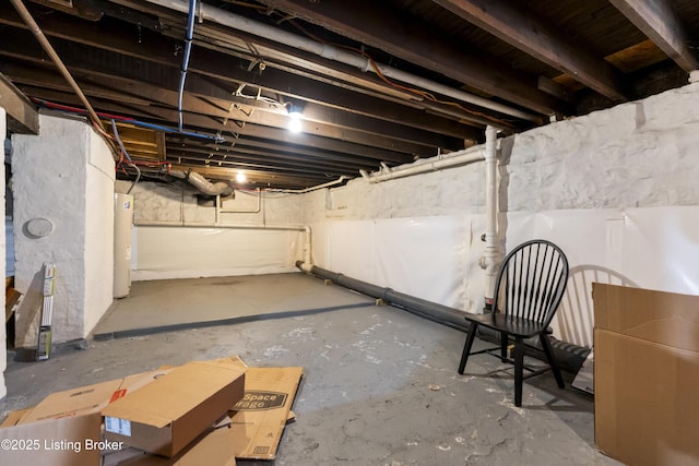 unfinished basement featuring water heater