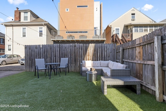 view of yard featuring outdoor lounge area and fence