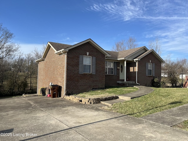 ranch-style house with a front yard and brick siding