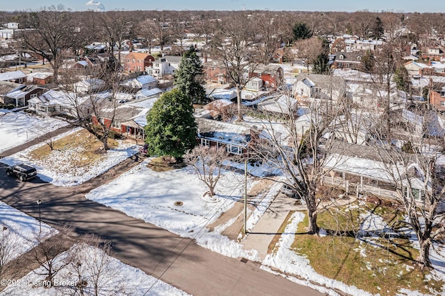 snowy aerial view with a residential view