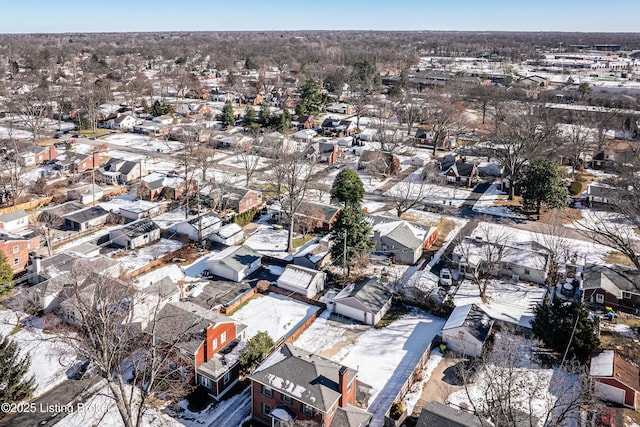 snowy aerial view featuring a residential view