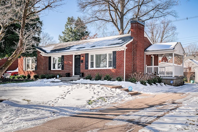 ranch-style home with brick siding and a chimney