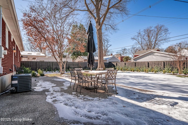 view of patio featuring outdoor dining space, central AC, and a fenced backyard