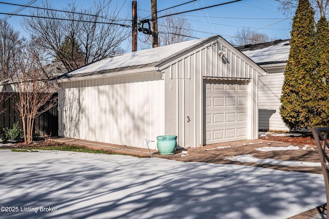 detached garage featuring fence