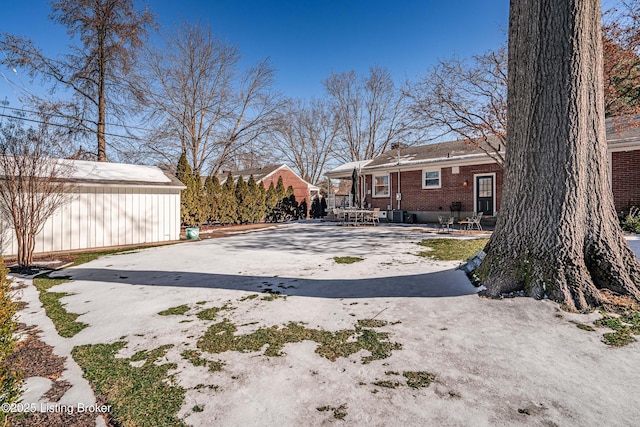 view of yard featuring driveway and a patio