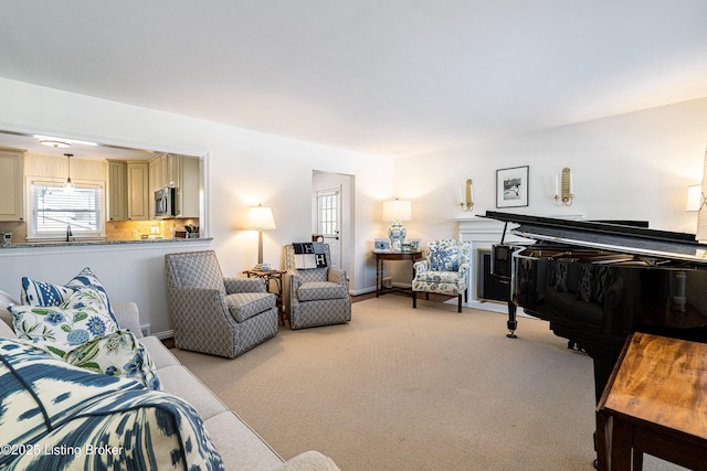 living room with baseboards and light colored carpet