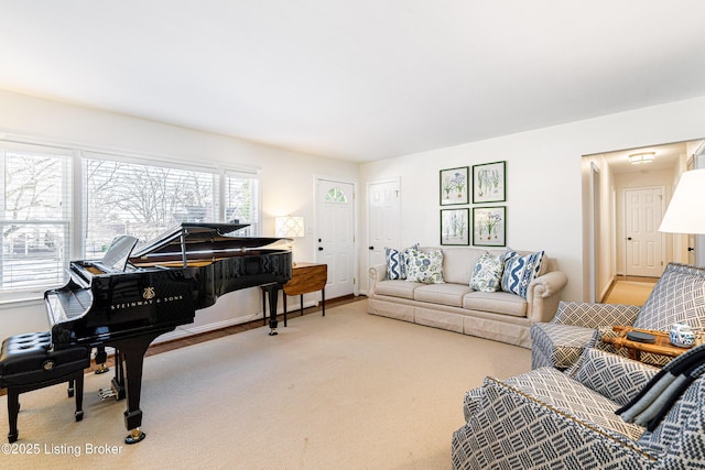 living area with baseboards and carpet flooring