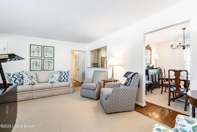 living area with an inviting chandelier and wood finished floors