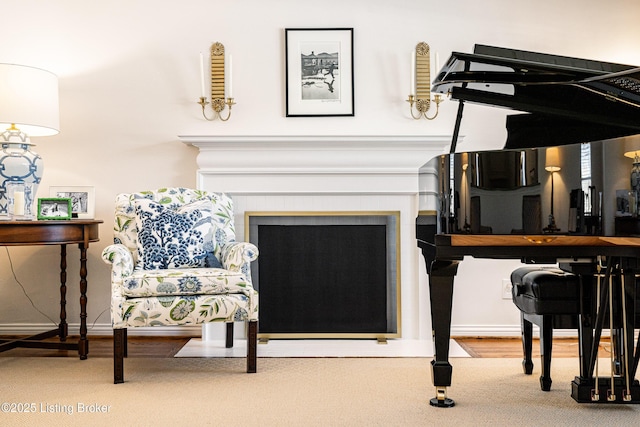 living area featuring carpet flooring, a fireplace, and baseboards