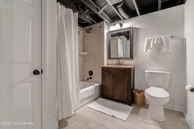 full bathroom with baseboards, vanity, toilet, and shower / bath combo with shower curtain