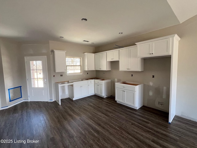 kitchen featuring dark wood-style floors and white cabinetry