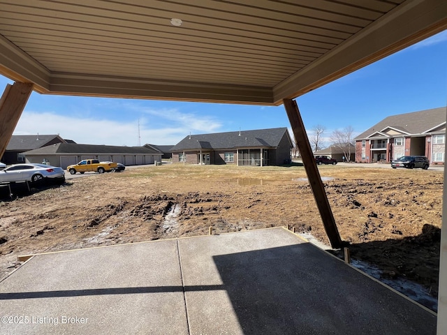 view of yard featuring a residential view and a patio area