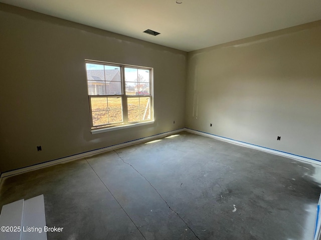 unfurnished room featuring concrete floors