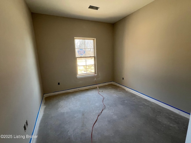 unfurnished room with unfinished concrete floors