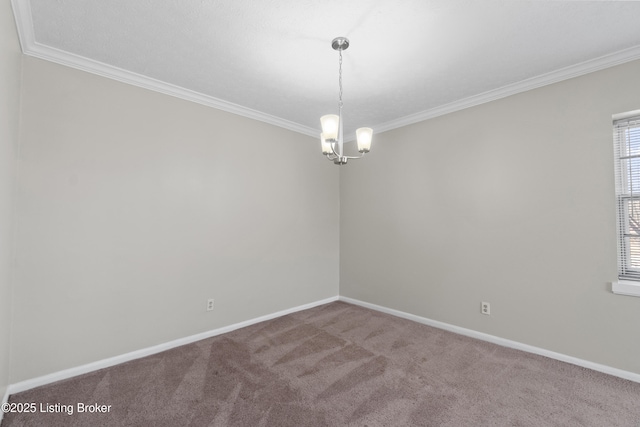 carpeted empty room featuring a chandelier, baseboards, and crown molding