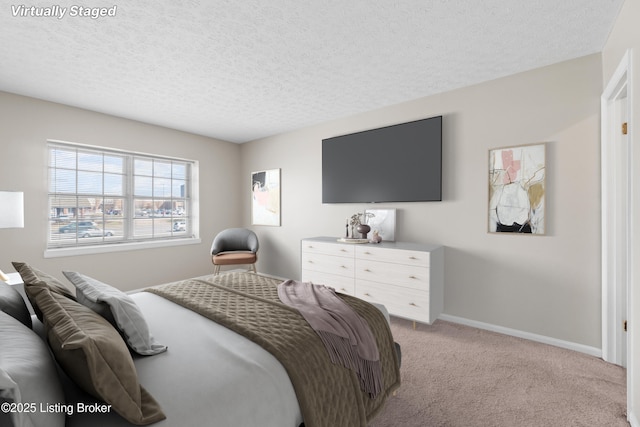 bedroom with baseboards, a textured ceiling, and light colored carpet