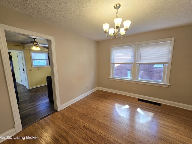 unfurnished room with baseboards, visible vents, and dark wood-style flooring